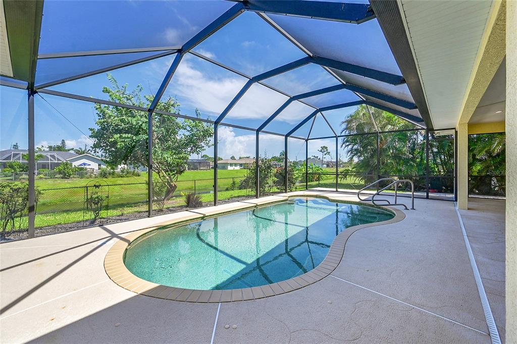 233 Fairway Road Rotonda West, FL 33947 - Photo 7 of 63 a view of a swimming pool with a yard