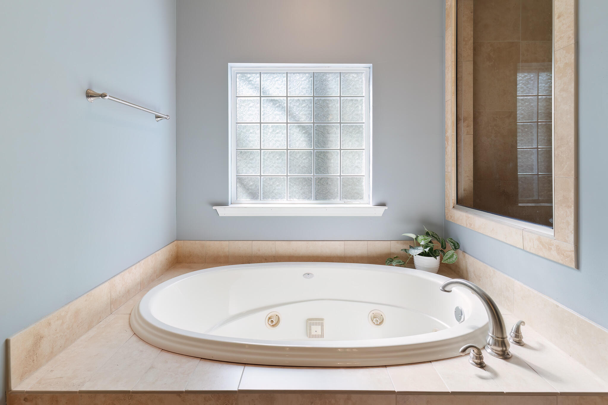 4353 Poverty Creek Road Crestview, FL 32539 - Photo 25 of 43 a white bath tub sitting in a bathroom next to a window