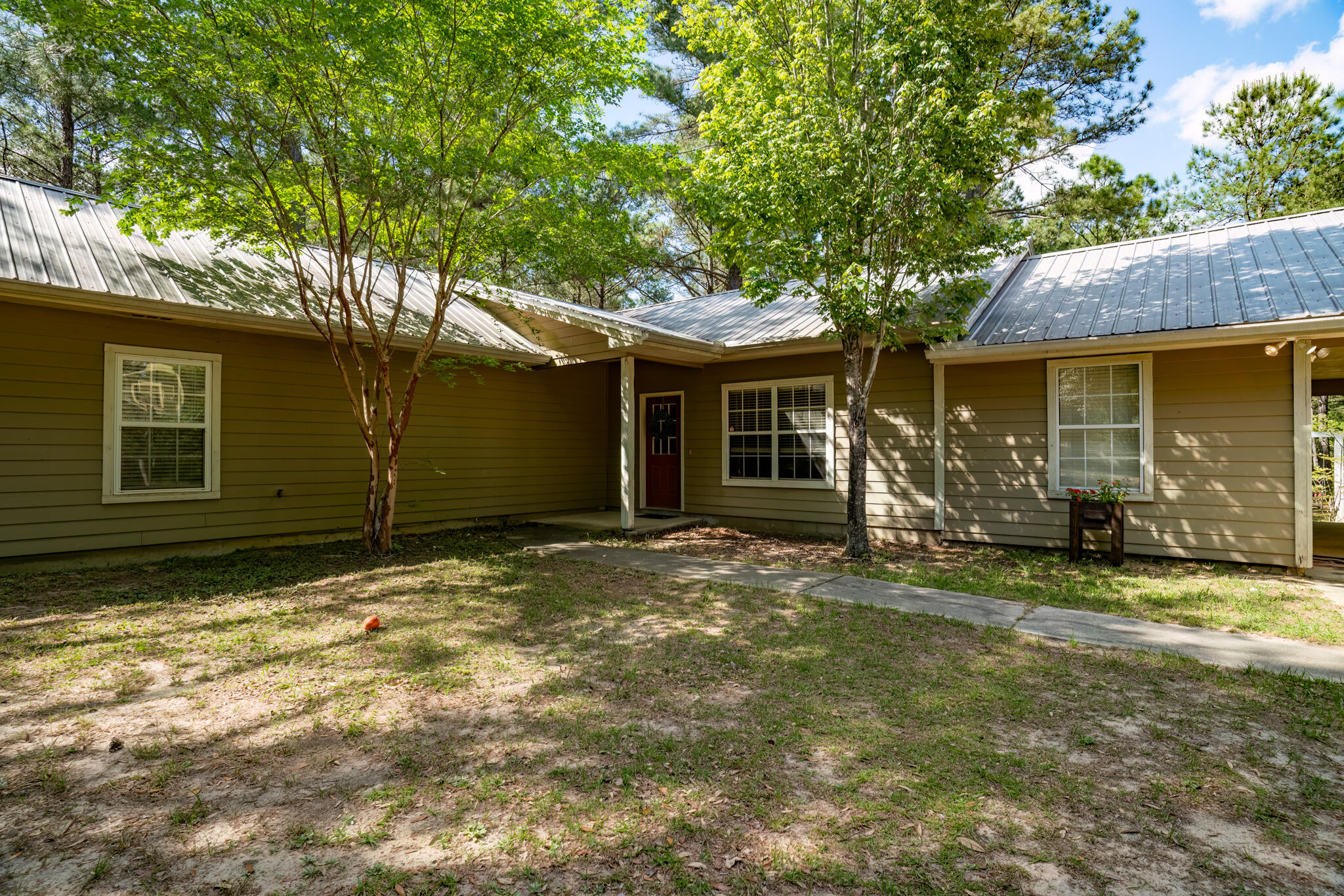 4353 Poverty Creek Road Crestview, FL 32539 - Photo 10 of 43 a view of a house with backyard and sitting area