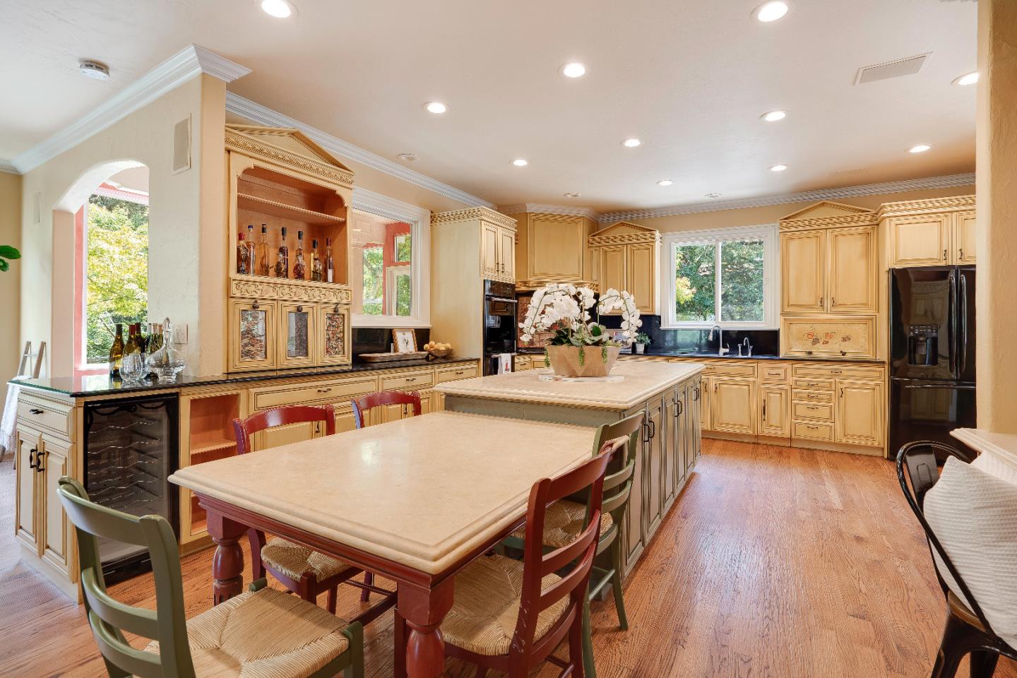 843 Chiltern Road Hillsborough, CA 94010 - Photo 22 of 94 a kitchen with stainless steel appliances granite countertop a stove a refrigerator a kitchen island a table and chairs