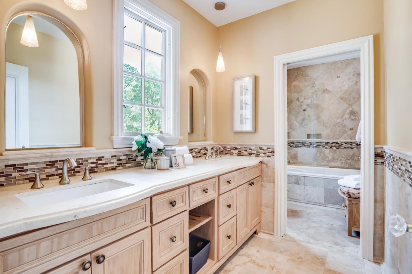 843 Chiltern Road Hillsborough, CA 94010 - Photo 64 of 94 a bathroom with a double vanity sink a mirror and a bathtub
