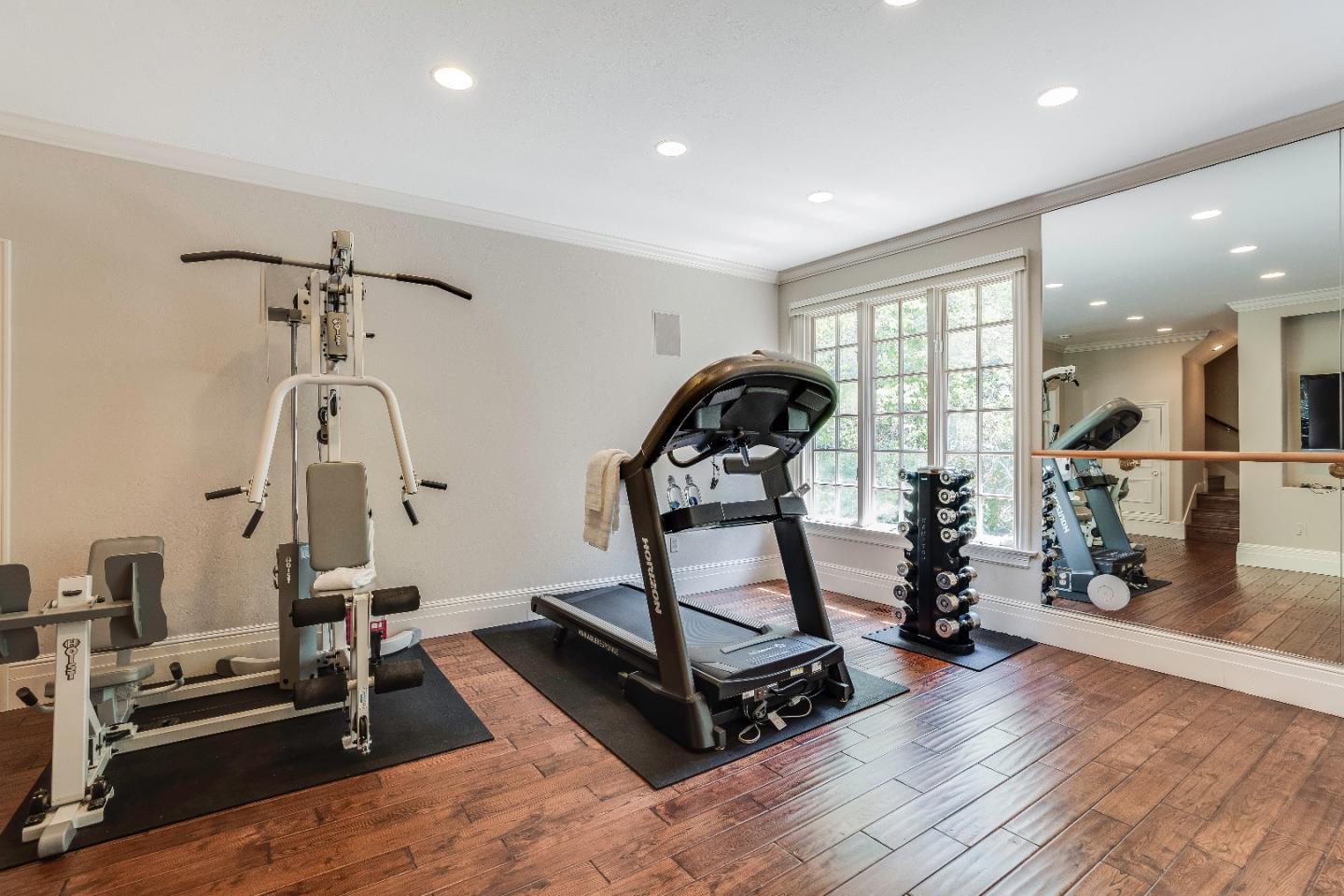 843 Chiltern Road Hillsborough, CA 94010 - Photo 71 of 94 a room with gym equipment and wooden floor