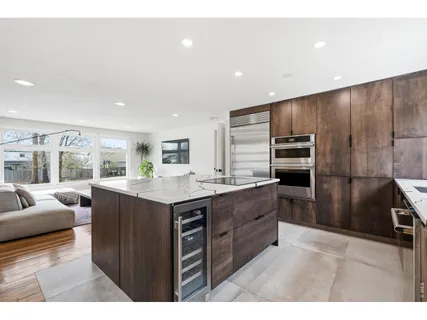 a kitchen with stainless steel appliances granite countertop a sink and a stove