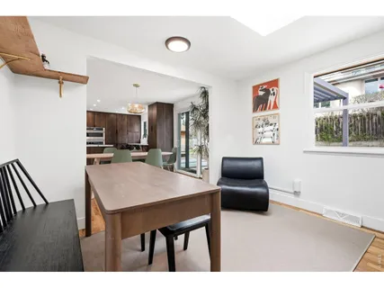 a kitchen with furniture and wooden floor
