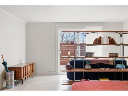 a living room with furniture a window and a lamp