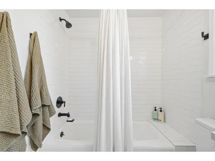 a bathroom with a bathtub and shower