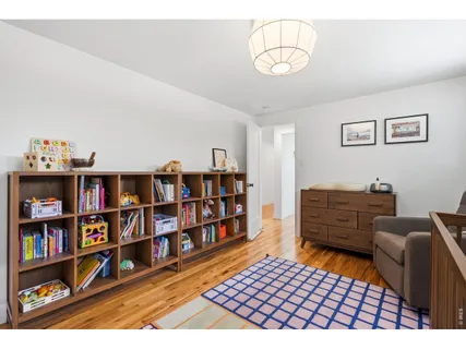 a bedroom with furniture and a book shelf