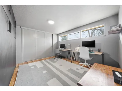 a living room with furniture a flat screen tv and a table