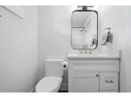 a bathroom with a sink mirror and toilet