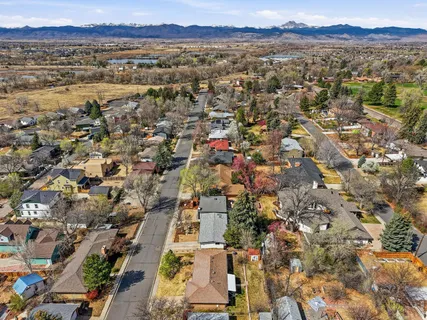 an aerial view of residential building with parking and yard