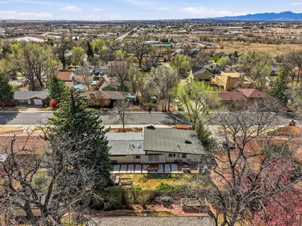 an aerial view of residential houses with city view