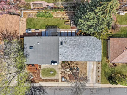 an aerial view of residential houses with outdoor space and parking