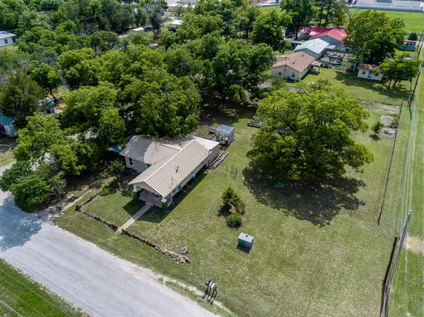 an aerial view of a house with yard
