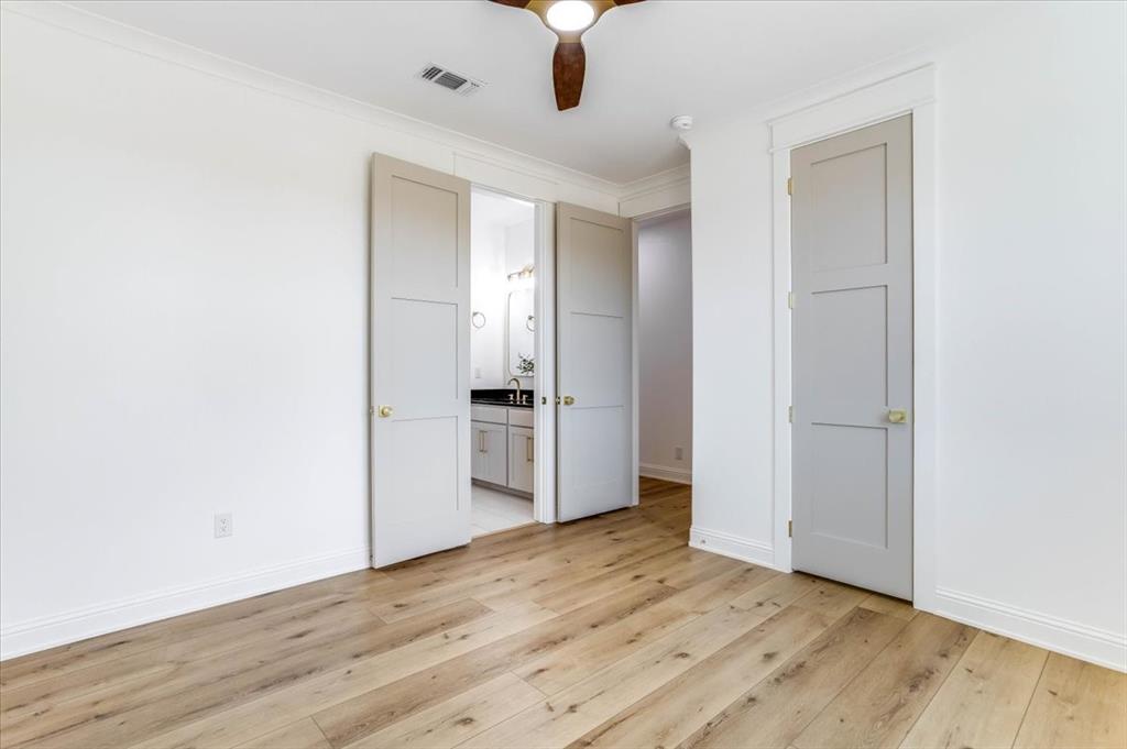 242 Private Road Mount Pleasant, TX 75455 - Photo 27 of 40 Wood-finish flooring throughout, white crown molding, and recessed lighting