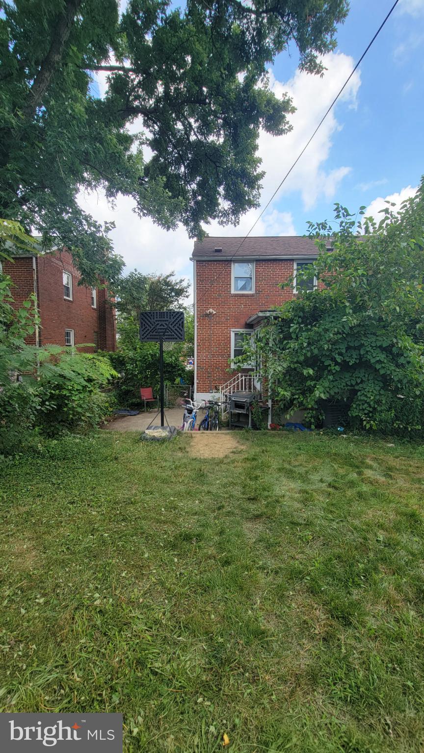 5105 Plymouth Road Baltimore, MD 21214 - Photo 2 of 29 Charming backyard oasis with lush greenery.