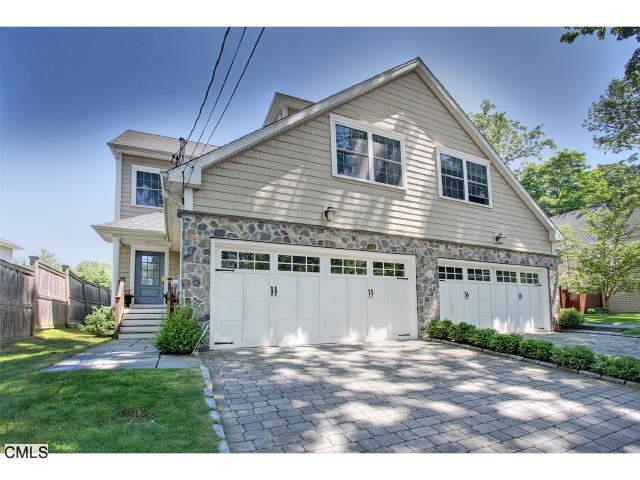 116 Spruce Street Fairfield, CT 06890 - Photo 1 of 1 a front view of a house with a garden