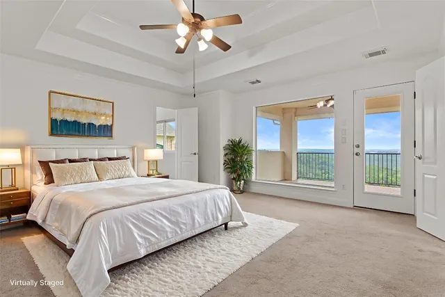 a spacious bedroom with a large bed and a large window