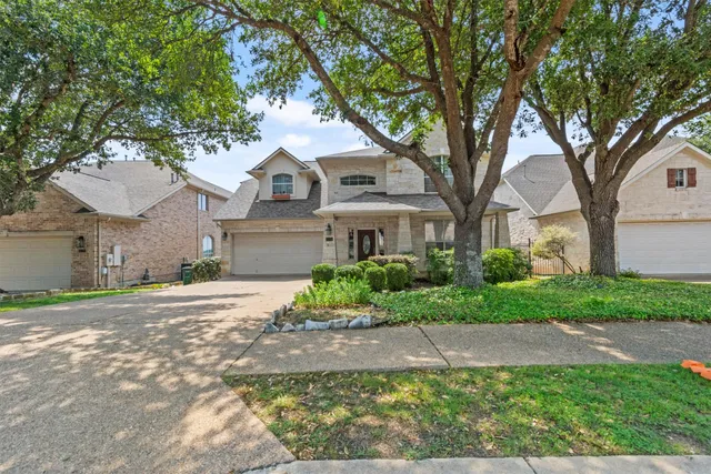 a front view of a house with a yard and a garage