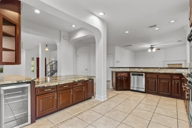 a kitchen with stainless steel appliances granite countertop a stove and a sink