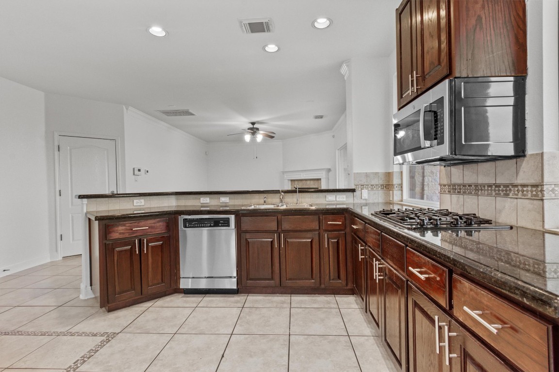 5724 Brittlyns Court Austin, TX 78730 - Photo 14 of 40 a kitchen with stainless steel appliances granite countertop a stove and a sink