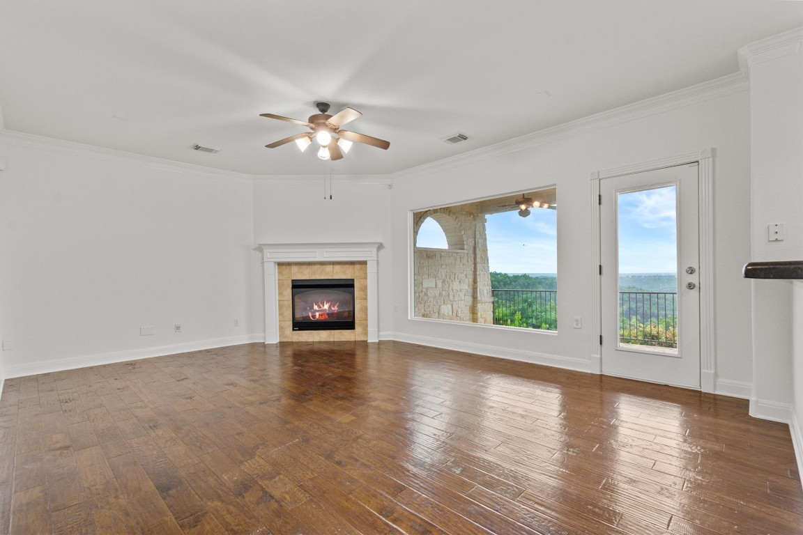 5724 Brittlyns Court Austin, TX 78730 - Photo 17 of 40 a view of an empty room with a window and wooden floor