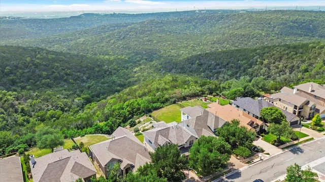 an aerial view of a house with a yard