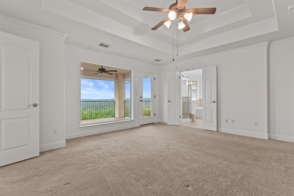 5724 Brittlyns Court Austin, TX 78730 - Photo 21 of 40 an empty room with chandelier fan and windows