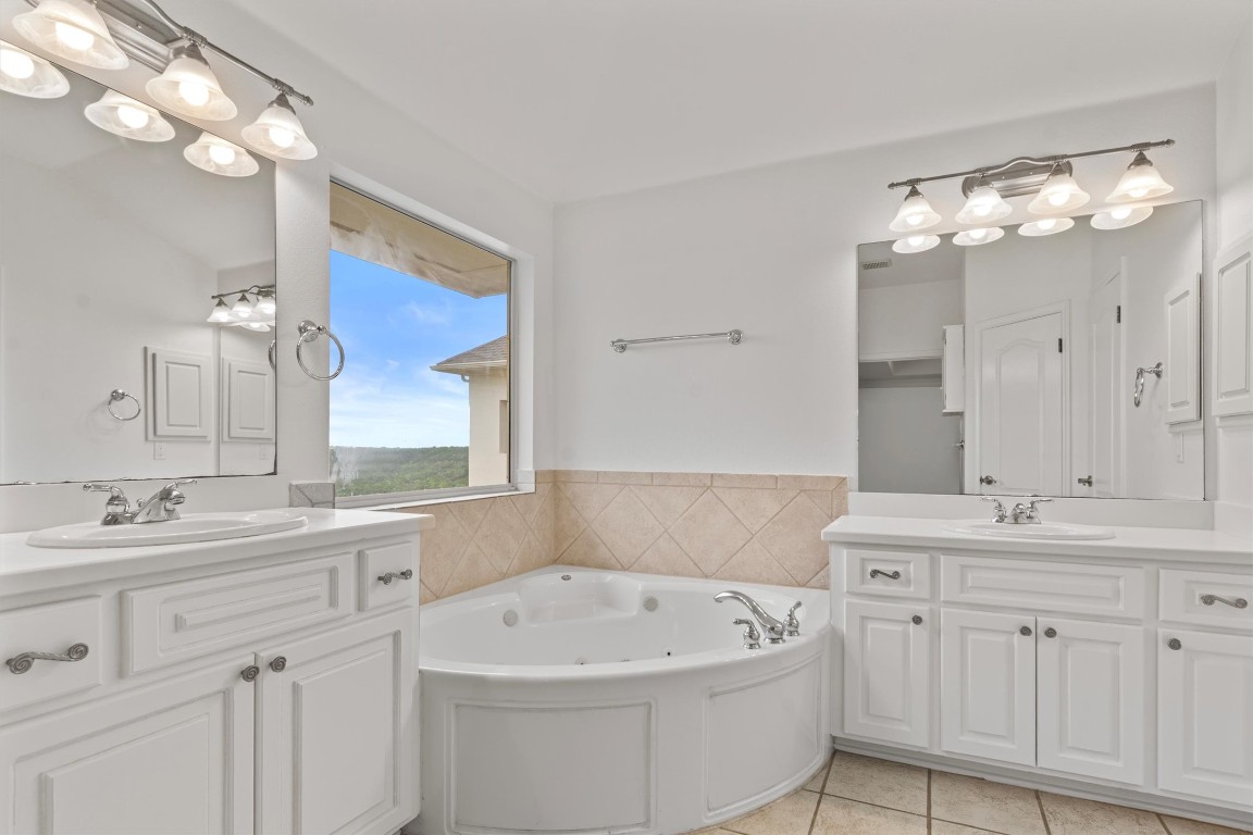 5724 Brittlyns Court Austin, TX 78730 - Photo 24 of 40 a bathroom with a sink vanity mirror and bathtub