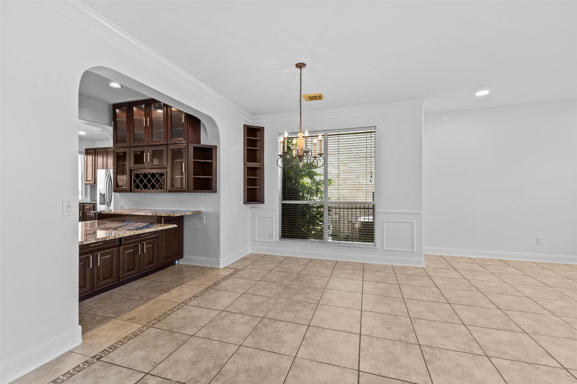 5724 Brittlyns Court Austin, TX 78730 - Photo 9 of 40 a large white kitchen with granite countertop a stove top oven a sink and a window