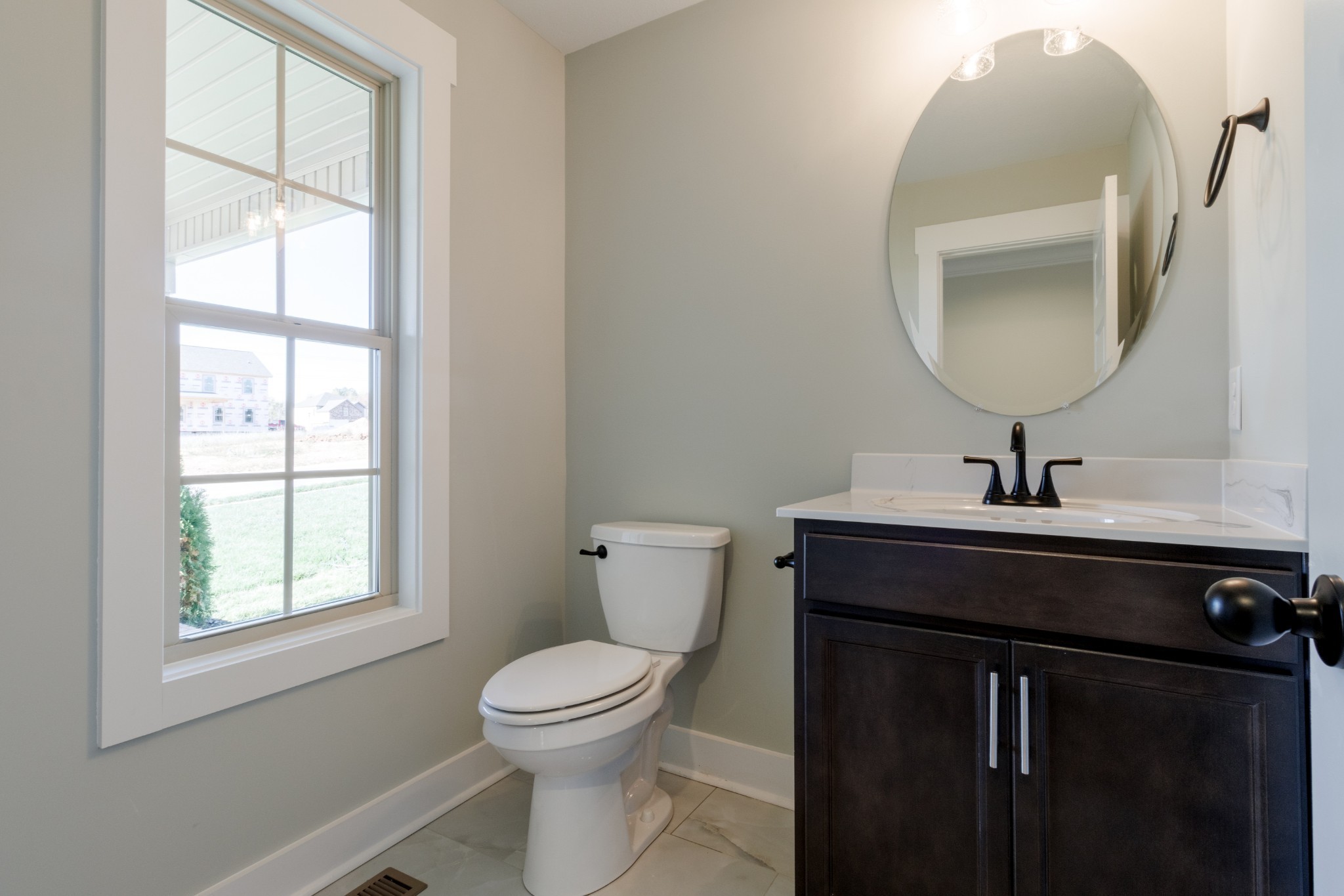 846 Limestone Way Clarksville, TN 37043 - Photo 12 of 30 a bathroom with a toilet a sink a window and mirror