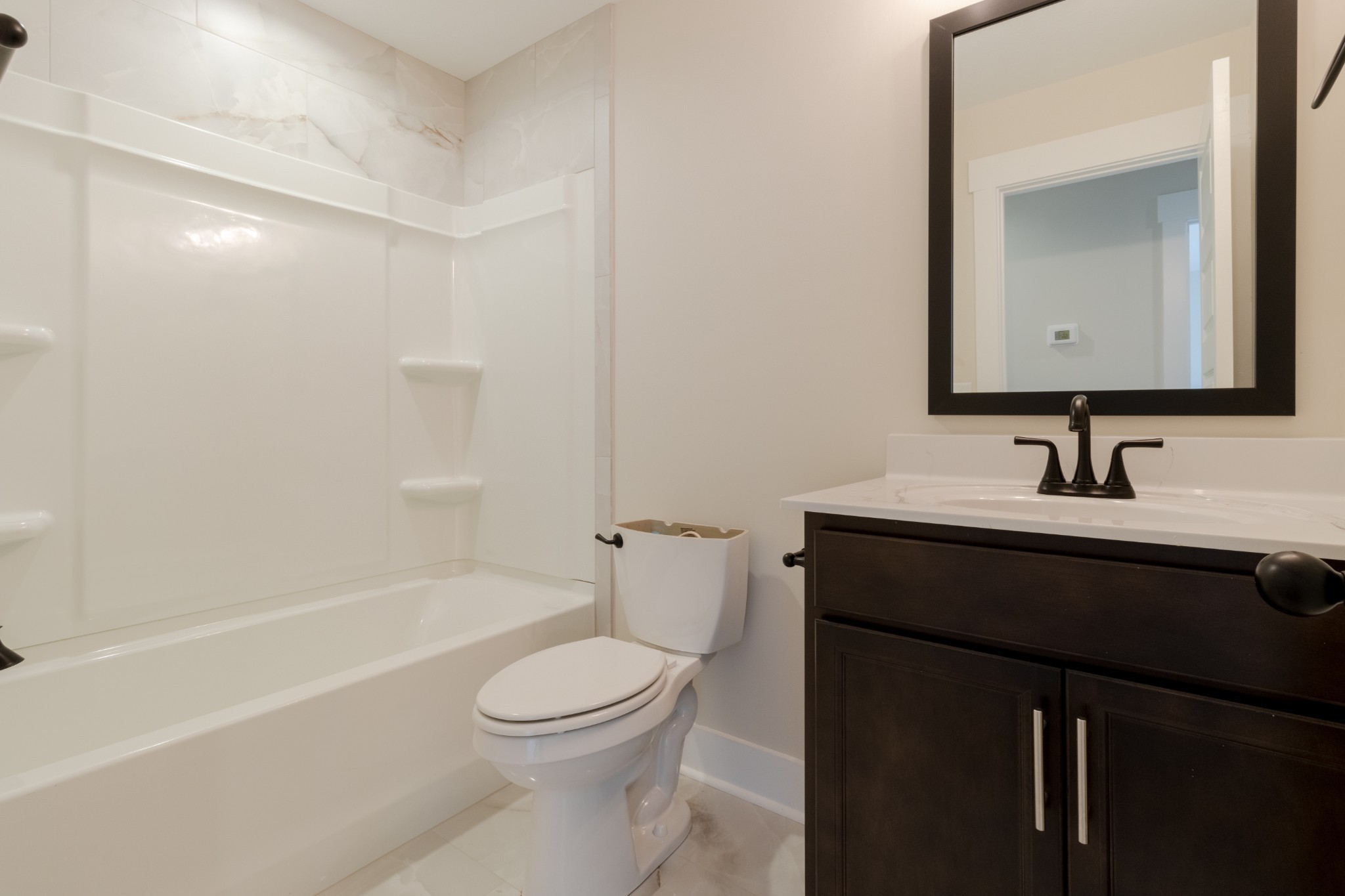 846 Limestone Way Clarksville, TN 37043 - Photo 23 of 30 a bathroom with a sink a toilet a mirror and shower