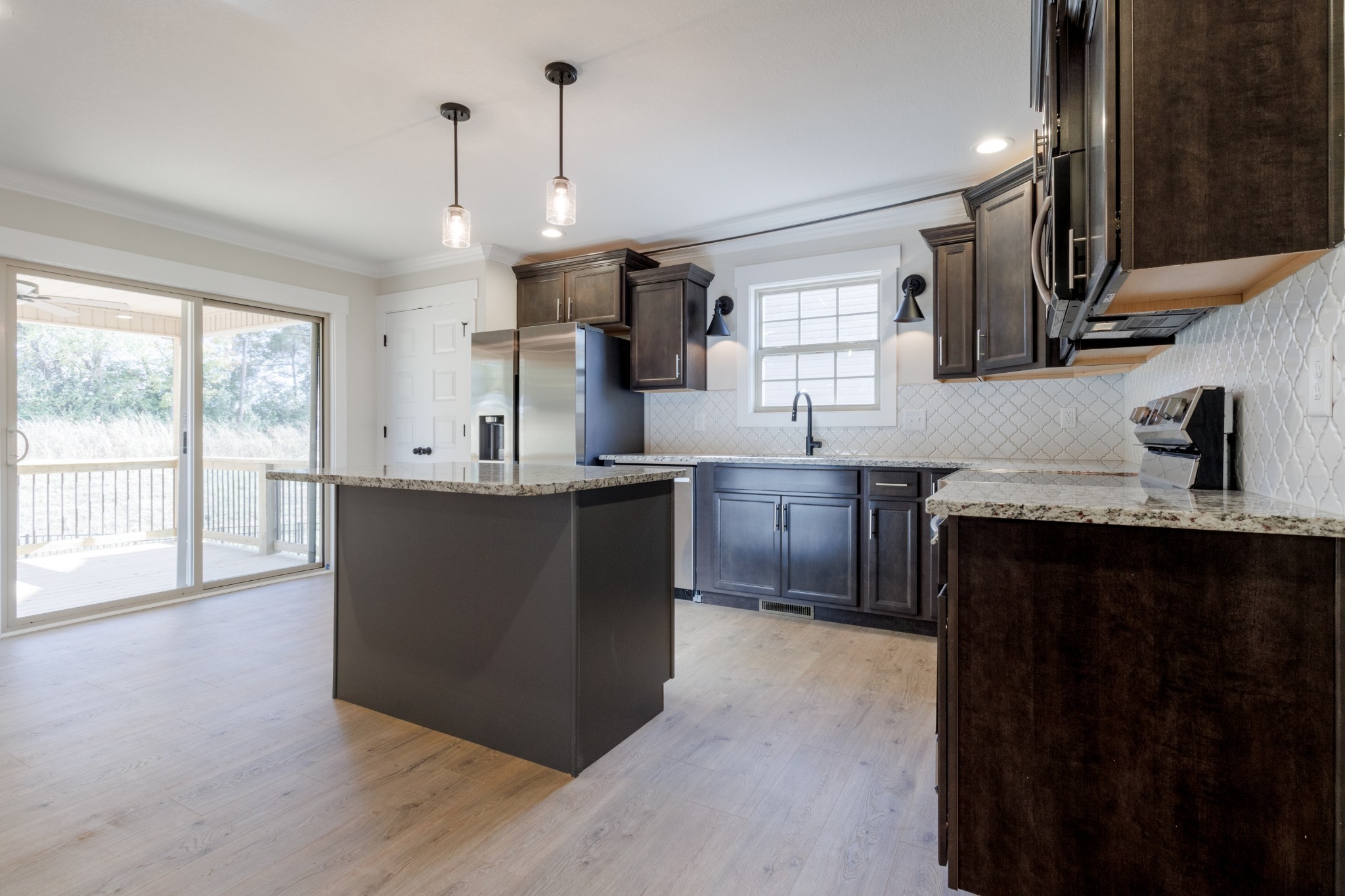 846 Limestone Way Clarksville, TN 37043 - Photo 9 of 30 a kitchen with stainless steel appliances granite countertop a sink a stove and a wooden floor