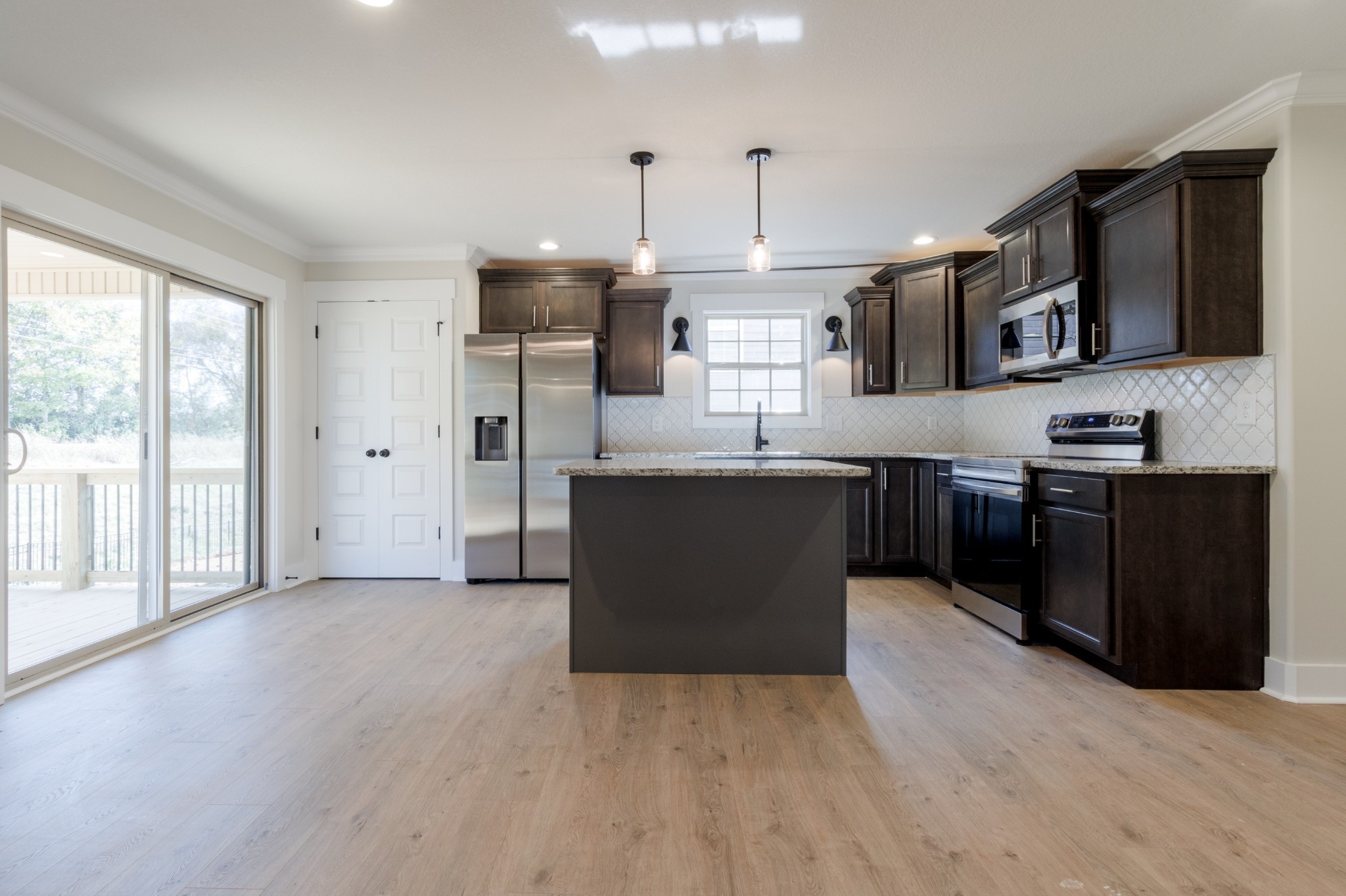 846 Limestone Way Clarksville, TN 37043 - Photo 10 of 30 a large kitchen with stainless steel appliances granite countertop a stove and a sink