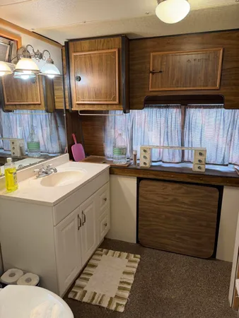 a utility room with a sink a cabinets and window