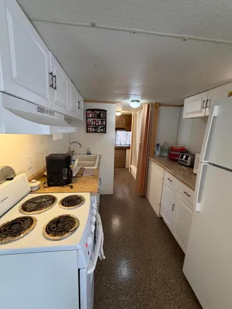 a kitchen with a sink a stove and refrigerator