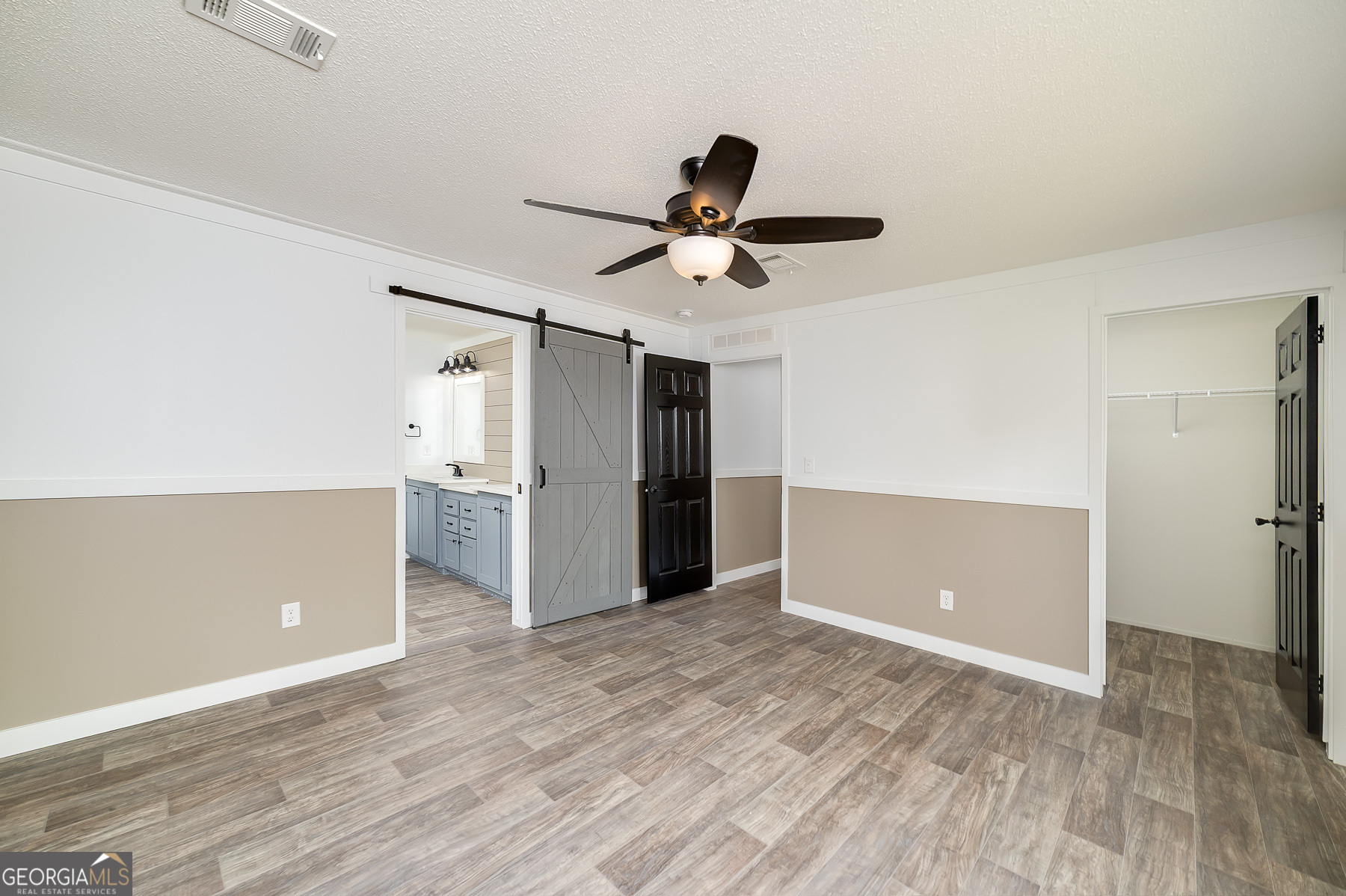 595 Barnetts Bridge Road Jackson, GA 30233 - Photo 27 of 47 a view of a livingroom with a ceiling fan & kitchen space