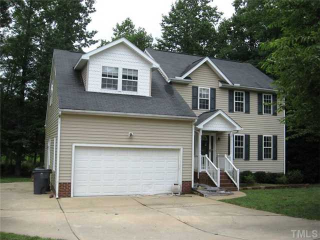 224 Crossfire Road Holly Springs, NC 27540 - Photo 1 of 7 a front view of a house with a yard and garage
