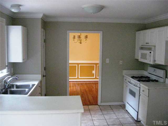 224 Crossfire Road Holly Springs, NC 27540 - Photo 3 of 7 a kitchen that has a sink a stove top oven and a window