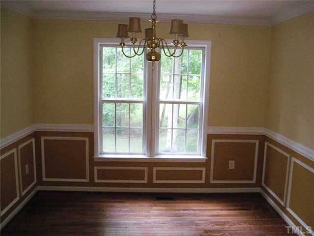 224 Crossfire Road Holly Springs, NC 27540 - Photo 4 of 7 a view of empty room with wooden floor and fan