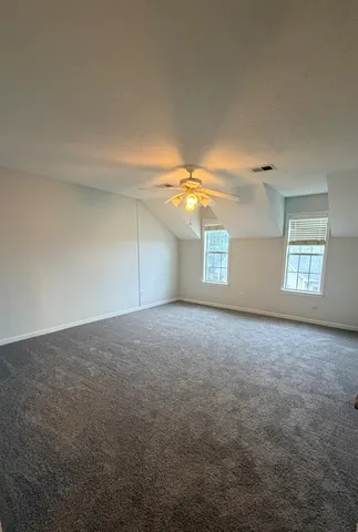 a view of a big room with windows and fireplace