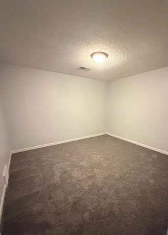 an empty room with a empty space and windows