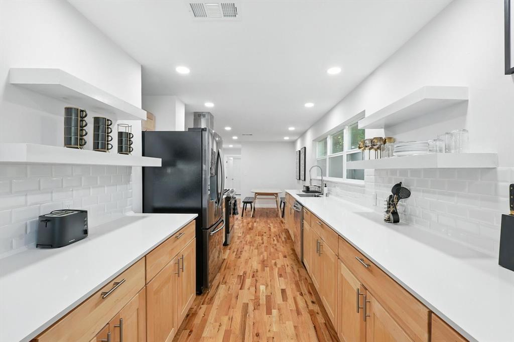 1009 Walnut Street Irving, TX 75060 - Photo 11 of 39 Kitchen with open shelves, backsplash, appliances with stainless steel finishes, and recessed lighting