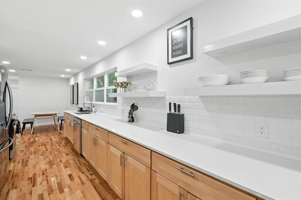 1009 Walnut Street Irving, TX 75060 - Photo 12 of 39 Kitchen with open shelves, tasteful backsplash, light wood-style flooring, recessed lighting, and appliances with stainless steel finishes