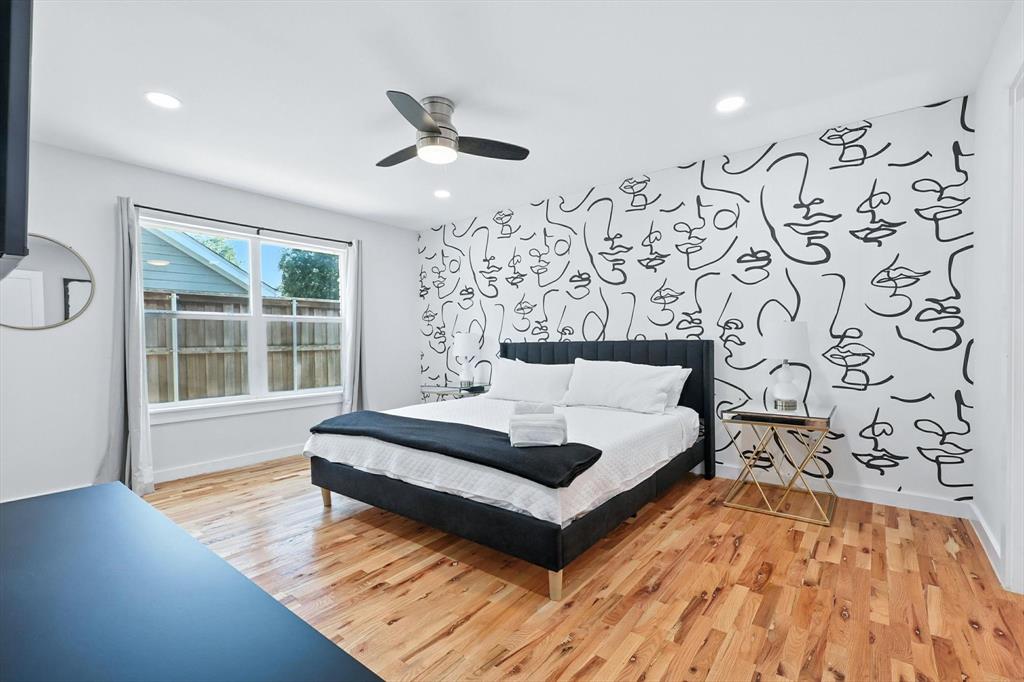 1009 Walnut Street Irving, TX 75060 - Photo 15 of 39 Bedroom featuring an accent wall, light wood-type flooring, a ceiling fan, and recessed lighting