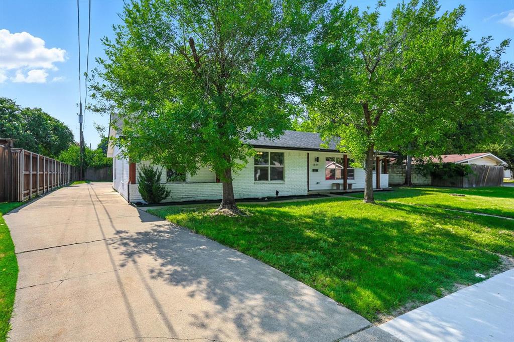 1009 Walnut Street Irving, TX 75060 - Photo 2 of 39 View of front of home featuring brick siding and concrete driveway