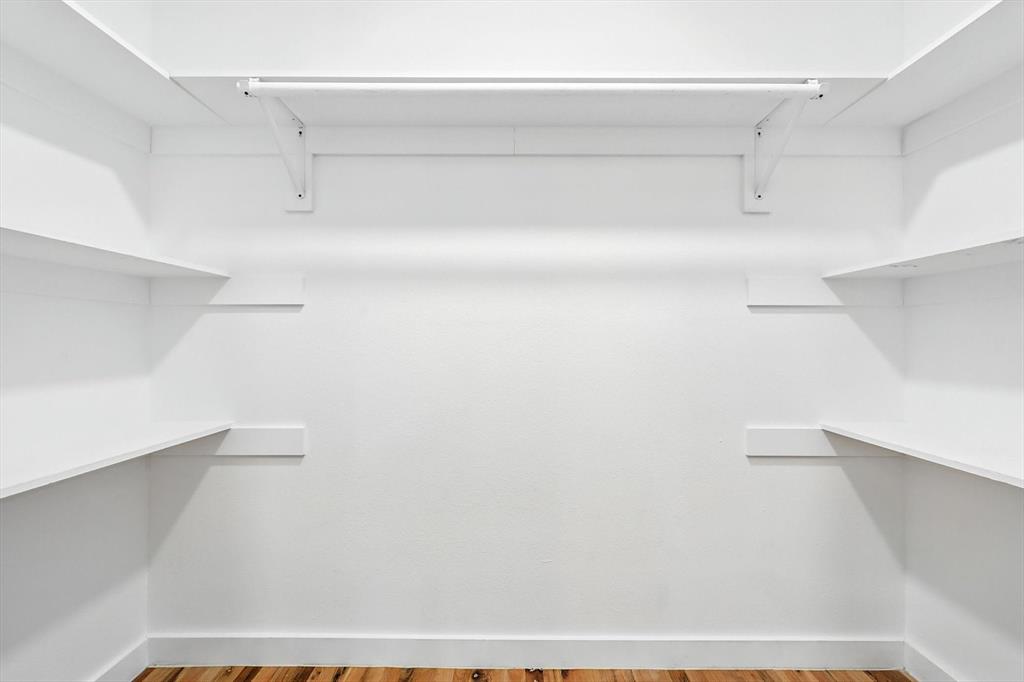 1009 Walnut Street Irving, TX 75060 - Photo 21 of 39 Spacious closet with light wood finished floors