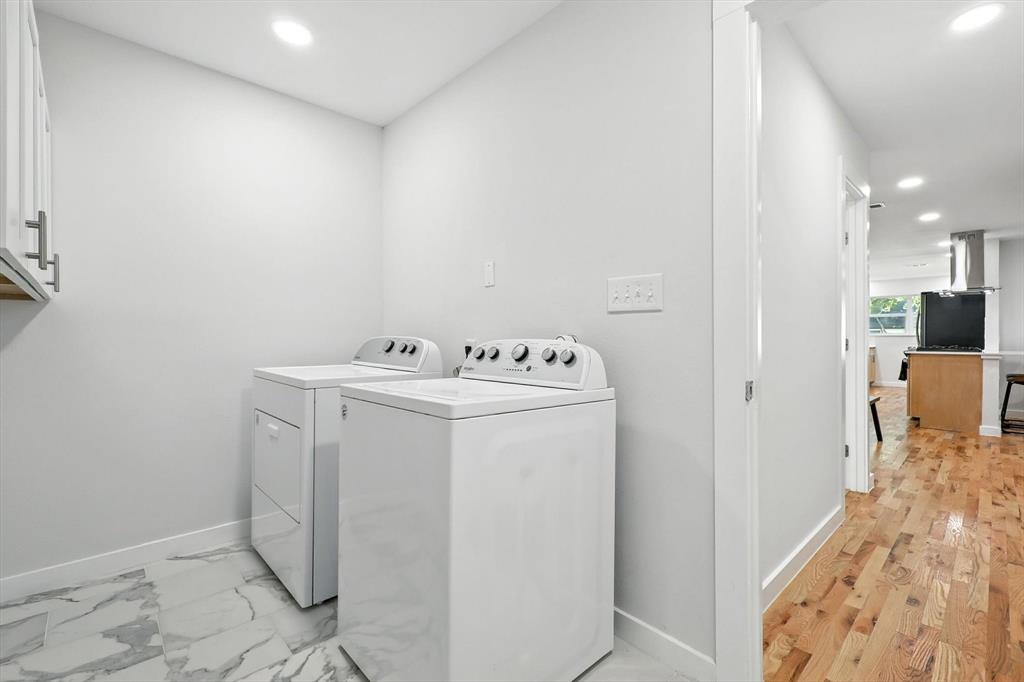 1009 Walnut Street Irving, TX 75060 - Photo 30 of 39 Laundry room featuring recessed lighting, washing machine and clothes dryer, and cabinet space