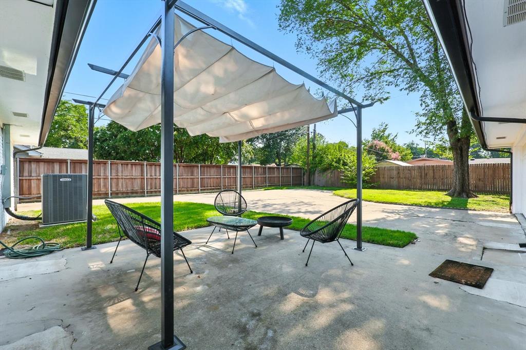1009 Walnut Street Irving, TX 75060 - Photo 31 of 39 Fenced backyard with a patio and a sunroom