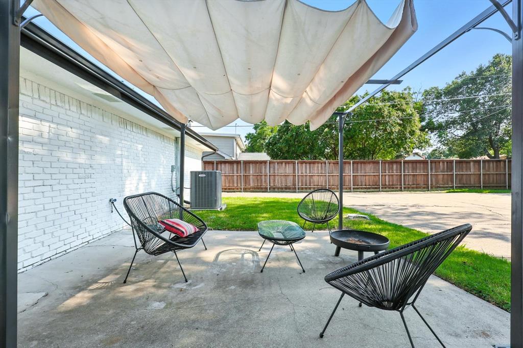 1009 Walnut Street Irving, TX 75060 - Photo 32 of 39 Fenced backyard with a patio area and a fire pit