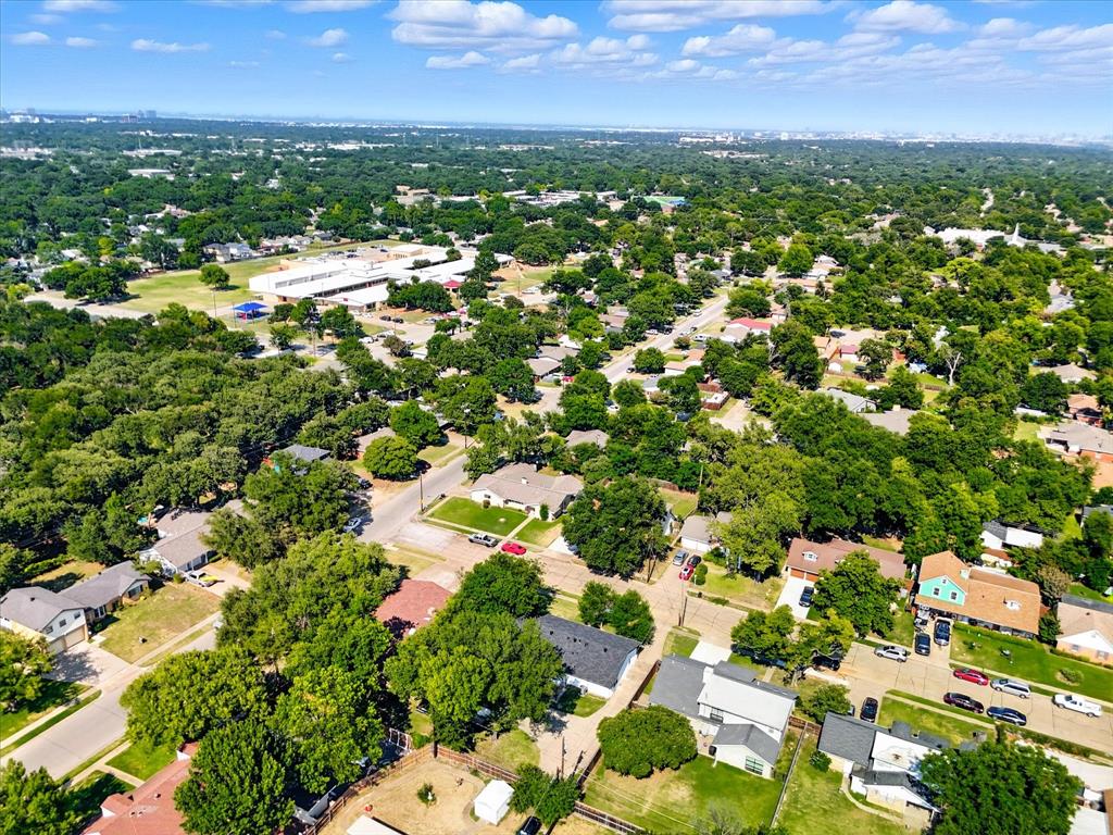 1009 Walnut Street Irving, TX 75060 - Photo 38 of 39 Aerial view of residential area with a tree filled landscape